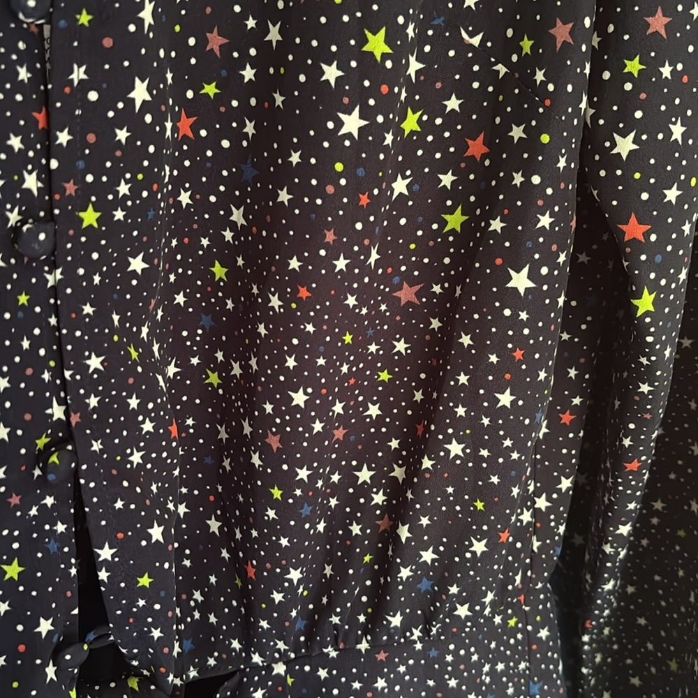 Navy romper (shorts) with colourful stars.  NWT “Likely” brand. Size 8